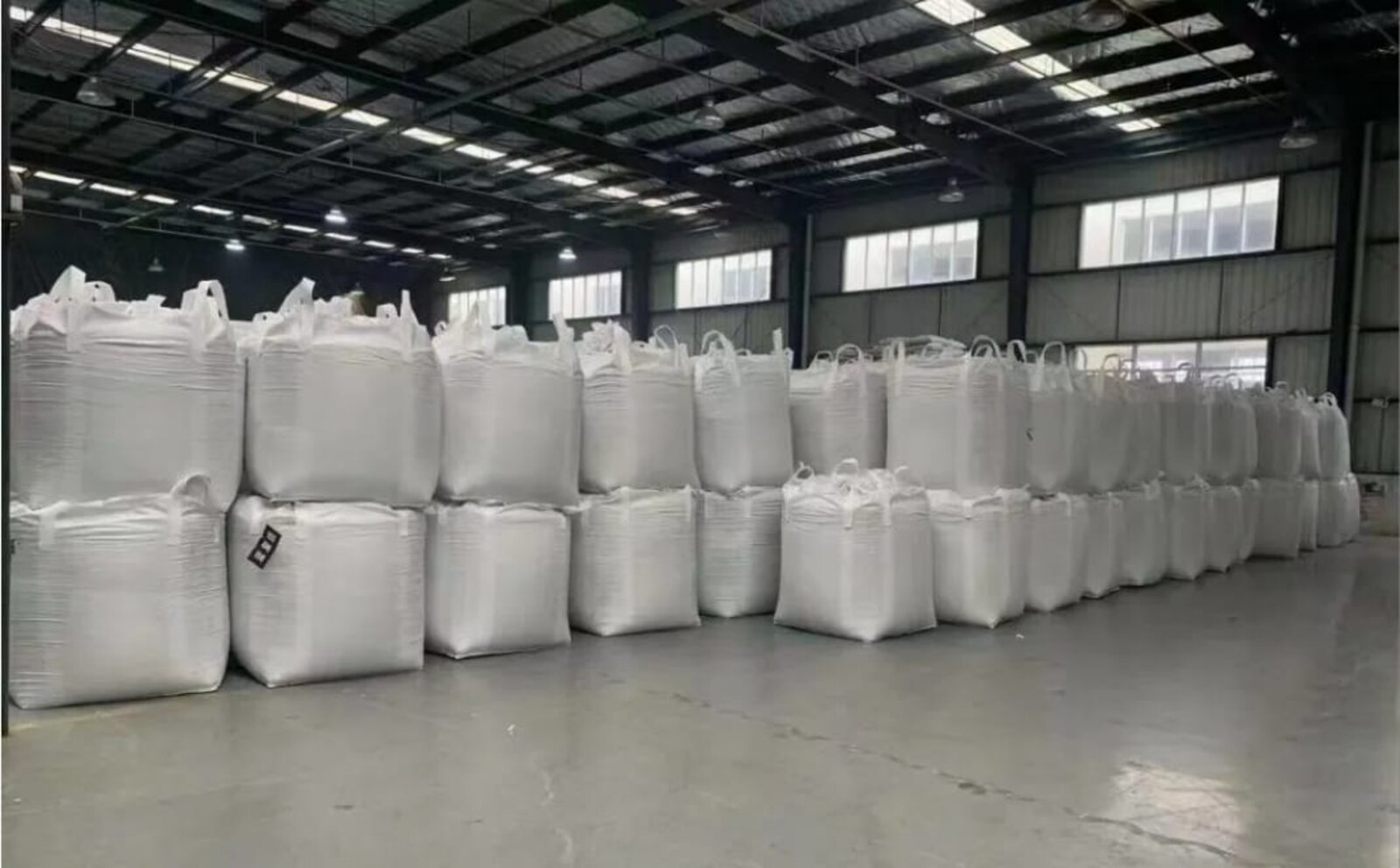 Industrial warehouse stacked with white FIBC bulk bags